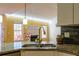 Contemporary kitchen design featuring granite countertops, a stainless steel sink, and an open view to the adjacent living room at 1305 Bramlett Forest Trail Southeast Trl, Lawrenceville, GA 30045