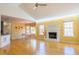 Bright and spacious living room featuring hardwood floors, a fireplace, and large windows that let in plenty of natural light at 1305 Bramlett Forest Trail Southeast Trl, Lawrenceville, GA 30045