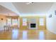 Inviting living room with a white-painted fireplace, hardwood floors, and large windows overlooking a spacious outdoor view at 1305 Bramlett Forest Trail Southeast Trl, Lawrenceville, GA 30045