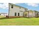 Large green backyard with white home and covered porch at 241 Martin Spring, Lawrenceville, GA 30045