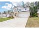 Attractive two-story home with a large driveway, attached garage, and well-manicured lawn, showcasing its curb appeal at 241 Martin Spring, Lawrenceville, GA 30045