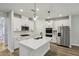 Modern kitchen featuring white cabinets, quartz countertops, stainless steel appliances, and an island with a sink at 241 Martin Spring, Lawrenceville, GA 30045