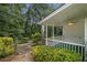 Charming back porch with white railings overlooking a lush, green garden and backyard at 2983 Peek Nw Rd, Atlanta, GA 30318
