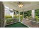 Covered porch featuring a ceiling fan and views of the greenery in the backyard at 2983 Peek Nw Rd, Atlanta, GA 30318
