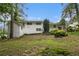 Exterior of the home featuring white siding, well-maintained landscaping, and mature trees at 2983 Peek Nw Rd, Atlanta, GA 30318