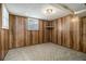 Finished basement with wood paneling, carpet, and two windows providing natural light at 2983 Peek Nw Rd, Atlanta, GA 30318