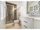 This bathroom offers a glass shower and a modern vanity with marble countertop and geometric mirror at 2983 Peek Nw Rd, Atlanta, GA 30318