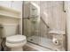 Well-lit bathroom featuring a glass-enclosed shower, built-in shelving, and modern fixtures at 2983 Peek Nw Rd, Atlanta, GA 30318