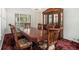 Traditional dining room with hardwood table, patterned chairs, chandelier, and large window for bright natural light at 2983 Peek Nw Rd, Atlanta, GA 30318