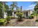 Charming exterior with white siding, a covered porch, and mature landscaping at 2983 Peek Nw Rd, Atlanta, GA 30318