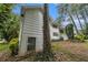 View of the back of the house showing white siding, a walkout basement and windows at 2983 Peek Nw Rd, Atlanta, GA 30318