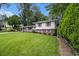 Charming split-level home with a well-manicured lawn and colorful shutters at 2983 Peek Nw Rd, Atlanta, GA 30318
