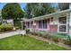 Charming split-level home with a well-manicured lawn and colorful shutters at 2983 Peek Nw Rd, Atlanta, GA 30318
