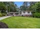 Charming split-level home with a well-manicured lawn and colorful shutters at 2983 Peek Nw Rd, Atlanta, GA 30318