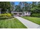 Charming split-level home with a well-manicured lawn and colorful shutters at 2983 Peek Nw Rd, Atlanta, GA 30318