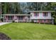 Charming split-level home with a well-manicured lawn and colorful shutters at 2983 Peek Nw Rd, Atlanta, GA 30318