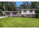 Charming split-level home with a well-manicured lawn and colorful shutters at 2983 Peek Nw Rd, Atlanta, GA 30318