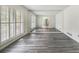 Bright living room featuring grey wood floors and large windows with white shutters at 2983 Peek Nw Rd, Atlanta, GA 30318