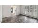Bright living room featuring grey wood floors and large windows with white shutters at 2983 Peek Nw Rd, Atlanta, GA 30318