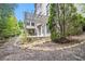 Backyard featuring stone patio, a wooden pergola, and beautiful landscaping at 3015 Southmoor Trce, Roswell, GA 30075