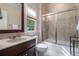 Well-lit bathroom features a vanity with a sink, a toilet, and a shower-tub with sliding glass doors at 3015 Southmoor Trce, Roswell, GA 30075