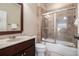 A cozy bathroom features a vanity, a toilet, and a shower/tub combo with sliding glass doors at 3015 Southmoor Trce, Roswell, GA 30075
