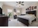 Cozy bedroom with a large bed, ceiling fan, and study area with ample natural light at 3015 Southmoor Trce, Roswell, GA 30075