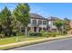Beautiful home featuring a manicured lawn and a symmetrical facade with a charming balcony and attached two-car garage at 3015 Southmoor Trce, Roswell, GA 30075