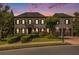 Beautiful home featuring a manicured lawn and a symmetrical facade with a charming balcony and attached two-car garage at 3015 Southmoor Trce, Roswell, GA 30075