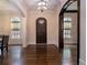Entry foyer featuring hardwood floors, arched doorways, and a dark wood front door at 3015 Southmoor Trce, Roswell, GA 30075
