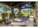 Inviting gazebo featuring comfortable seating, a stone fireplace, and lush landscaping at 3015 Southmoor Trce, Roswell, GA 30075