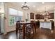 Eat-in kitchen features a center island, pendant lighting, stainless appliances, and plenty of cabinets at 3015 Southmoor Trce, Roswell, GA 30075