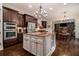 Spacious kitchen with stainless appliances, granite counters, and hardwood floors open to the dining area at 3015 Southmoor Trce, Roswell, GA 30075