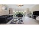 Bright living room with bay windows, comfortable sofas, and a decorative rug at 3015 Southmoor Trce, Roswell, GA 30075