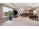 Spacious living room features large windows, recessed lighting, and a comfortable leather sectional at 3015 Southmoor Trce, Roswell, GA 30075
