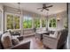 Cozy sunroom filled with natural light, comfortable wicker seating, and views of the lush backyard at 3015 Southmoor Trce, Roswell, GA 30075