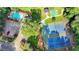 Aerial view showcasing community pool, tennis courts, and surrounding lush landscaping at 4845 Dartford Dr, Powder Springs, GA 30127