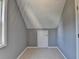 Cozy attic space with carpet and a door, ready for storage or customization at 4845 Dartford Dr, Powder Springs, GA 30127