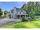 Charming two-story home with backyard view, inviting covered porch, and lush landscaping at 4845 Dartford Dr, Powder Springs, GA 30127