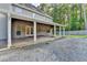 Rear exterior of home with a covered back porch and a patio on a lush lot at 4845 Dartford Dr, Powder Springs, GA 30127