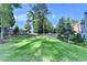 Beautifully landscaped backyard with mature trees, a lush lawn, and a wooden fence at 4845 Dartford Dr, Powder Springs, GA 30127