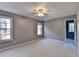 Spacious bedroom with neutral carpet, two windows providing great light, and a ceiling fan at 4845 Dartford Dr, Powder Springs, GA 30127