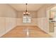 Bright dining room features hardwood floors, wainscotting, and a modern chandelier at 4845 Dartford Dr, Powder Springs, GA 30127