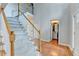 Open foyer featuring hardwood floors, a staircase, and a view of a half bathroom at 4845 Dartford Dr, Powder Springs, GA 30127