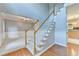 Bright foyer with hardwood floors, a staircase with white railings, and a glimpse into other rooms at 4845 Dartford Dr, Powder Springs, GA 30127