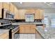 Kitchen with stainless steel appliances, granite countertops and light wood cabinetry at 4845 Dartford Dr, Powder Springs, GA 30127