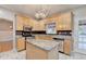 Well-lit kitchen with stainless appliances, granite countertops, tile backsplash, and wooden cabinets at 4845 Dartford Dr, Powder Springs, GA 30127