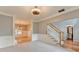 Inviting living room with carpet, with views of the staircase, front door, and a half bathroom at 4845 Dartford Dr, Powder Springs, GA 30127