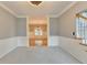 Spacious living room with carpet and a view into the adjacent dining room with hardwood floors at 4845 Dartford Dr, Powder Springs, GA 30127
