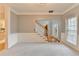 Open living room with a staircase, view to the front entrance and natural light through the window at 4845 Dartford Dr, Powder Springs, GA 30127
